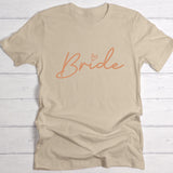 Beiges Damen T-Shirt Brustdruck "Bride" als personalisiertem Spruch als Hochzeitsgeschenkidee von Love & Faith